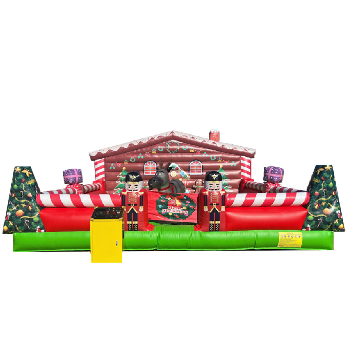 A large inflatable Christmas bounce house features a festive gingerbread house design with red and white stripes. Nutcracker figures stand at either side of a decorative sign that reads "Merry Christmas." A gray mechanical reindeer is positioned in the center, surrounded by colorful holiday accents, including ornaments.