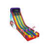 The image depicts a tall, colorful inflatable slide primarily in bright reds, yellows, and blues. The slide has three parallel sliding lanes, each defined by vertical stripes. The top features a black mesh for safety, while the base is decorated with red and white candy cane motifs. To the side, the slide showcases a winter scene with Santa Claus, adding to the festive ambiance. The composition highlights the slide against a solid white background, emphasizing its vibrant colors.
